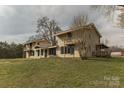 A spacious two-story house with a large lawn on a cloudy day offers country living at 3607 Austin Rd, Monroe, NC 28112
