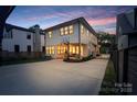 The back of the house features a patio with seating, a basketball hoop, and a driveway with a gated entrance at 508 Mcalway Rd, Charlotte, NC 28211