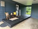 Cozy covered porch featuring seating, a welcome sign, and a tranquil outdoor space at 60 White Oaks Dr, Taylorsville, NC 28681