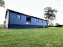 A view of the house, showing the backyard and the home's architecture at 60 White Oaks Dr, Taylorsville, NC 28681