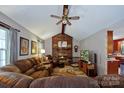 Comfortable living room features a brick fireplace, ceiling fan, and carpet, perfect for relaxation at 6039 Donna Dr, Charlotte, NC 28213