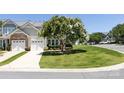 Townhome exterior with attached garage and well-maintained lawn and landscaping at 621 Pine Links Dr, Tega Cay, SC 29708