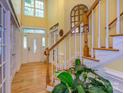 Grand foyer featuring a staircase and transom windows, complemented by hardwood floors at 6311 Red Maple Dr, Charlotte, NC 28277