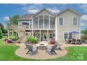 Spacious backyard with a fire pit area, multilevel deck and screened porch perfect for entertaining at 6326 Jepson Ct, Charlotte, NC 28214