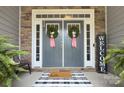 Inviting double front doors adorned with wreaths, a decorative welcome mat, and fresh fern accents at 6326 Jepson Ct, Charlotte, NC 28214