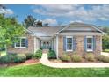 Charming stone home with manicured landscaping, inviting entrance, and beautiful curb appeal at 6326 Jepson Ct, Charlotte, NC 28214