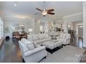 Open-concept living room with hardwood floors, comfortable seating, and abundant natural light at 6326 Jepson Ct, Charlotte, NC 28214