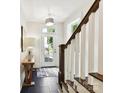 Bright foyer with a stylish staircase, slate floors, and an elegant console table at 6531 Hazelton Dr, Charlotte, NC 28210