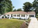 Beautiful home featuring a spacious driveway, attached garage, and professionally landscaped yard at 6745 Lancer Dr, Charlotte, NC 28226