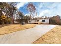 The house's exterior is complemented by a well-maintained front yard and a concrete driveway at 716 Sharon Ln, Iron Station, NC 28080