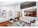 Stylish living room featuring built-in shelves and an open view to the kitchen at 7554 Bluestar Ln, Charlotte, NC 28226