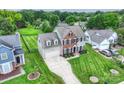 Aerial view of a two-story home with a well-maintained lawn and a long driveway at 8417 Hirsch Dr, Charlotte, NC 28277