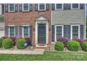 Close-up of the front door with brick facade and manicured landscaping enhancing curb appeal at 8417 Hirsch Dr, Charlotte, NC 28277