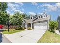 Well-manicured lawn of this home features an attached two-car garage and inviting front entrance at 101 Daybreak Ln, Belmont, NC 28012