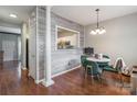 Dining area with hardwood floors, unique wall accents, and a view into the kitchen at 11521 Savannah Creek Dr, Charlotte, NC 28273