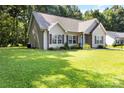 A charming single-story home with a well-maintained lawn, showcasing its curb appeal and setting at 117 Franklin St, Clover, SC 29710