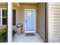 Welcoming front door with blue paint, decorative flower pot and 'Welcome' door mat at 117 Franklin St, Clover, SC 29710
