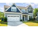 Beautiful home featuring a two-car garage, well-kept lawn, and inviting curb appeal at 12140 Mcdowell Pl, Huntersville, NC 28078