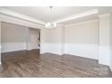 A spacious, open living room showcases hardwood floors, recessed lighting, and elegant wainscoting at 12140 Mcdowell Pl, Huntersville, NC 28078