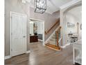 Inviting foyer with hardwood floors, staircase, and elegant lighting, showcasing a welcoming entrance at 17711 North Shore Cir, Cornelius, NC 28031