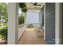 Cozy front porch with white rocking chairs and a ceiling fan, perfect for relaxing outdoors at 17711 North Shore Cir, Cornelius, NC 28031
