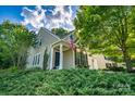 Charming home featuring manicured landscaping and a welcoming front porch at 18439 Victoria Bay Dr, Cornelius, NC 28031