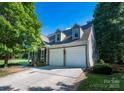 Spacious two-car garage with an inviting exterior and well-maintained driveway at 18439 Victoria Bay Dr, Cornelius, NC 28031