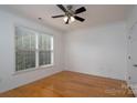 Bright bedroom with hardwood floors, natural light, and ceiling fan at 18730 Nautical Dr # 102, Cornelius, NC 28031