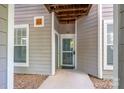 Ground level condo entrance featuring unit number and protected entry way at 18730 Nautical Dr # 102, Cornelius, NC 28031