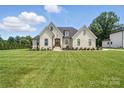 Charming brick home with a manicured lawn and professionally landscaped yard offers curb appeal at 19 Berea Baptist Church Rd, Stanfield, NC 28163