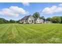 Sprawling lawn showcases the home's desirable location and picturesque surroundings at 19 Berea Baptist Church Rd, Stanfield, NC 28163