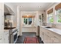 Modern kitchen with stainless steel appliances, tile backsplash, and a charming window seat at 2015 Lombardy Cir, Charlotte, NC 28203