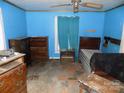 Bedroom interior showing blue walls, dated flooring, and furniture arrangement; needs renovation at 212 Huffman Rd, Gastonia, NC 28052