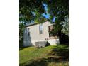 Exterior view of the back of the home and a lush green lawn at 215 9Th St, Spencer, NC 28159
