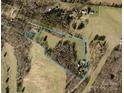 Aerial view of land parcel with boundary line highlighting acreage of land with trees and grass at 233 Hicks Rd, Statesville, NC 28625