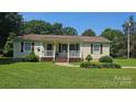 Inviting home with a cozy front porch, white railings, and charming curb appeal at 233 Hicks Rd, Statesville, NC 28625