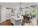 Spacious white kitchen and dining area with stainless steel appliances and access to the outdoor deck at 252 Broadleaf Dr, Denver, NC 28037