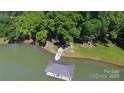 An aerial view of the covered pier on the lake, surrounded by trees at 2721 Nance Cove Rd, Charlotte, NC 28214