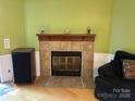 Inviting living room featuring a cozy fireplace with decorative tile surround and mantle at 2721 Nance Cove Rd, Charlotte, NC 28214