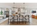Open kitchen with a large island, pendant lighting, white cabinets, and stainless steel appliances at 3010 Khan Park Dr # 68, Charlotte, NC 28206