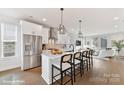 Open kitchen featuring a large island with seating, stainless steel appliances, and white cabinetry at 3010 Khan Park Dr # 68, Charlotte, NC 28206