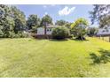 Expansive backyard featuring lush greenery and mature trees providing ample shade and privacy at 3419 Boat Club Rd, Belmont, NC 28012