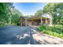 Brick home featuring a covered patio and a spacious driveway at 402 Scotland Dr, Kings Mountain, NC 28086