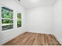 Bright bedroom with natural light, features wood-look flooring and neutral paint at 411 Patience Dr, Concord, NC 28025