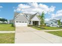 A beautiful single-Gathering house with a lush green lawn, gray siding, two-car garage, and inviting curb appeal at 507 Yucatan Dr # 71, Waxhaw, NC 28173