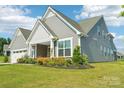 Charming two-story home with a lush green lawn, gray siding, and inviting curb appeal at 507 Yucatan Dr # 71, Waxhaw, NC 28173