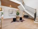 Grand foyer showcasing a striking staircase, hardwood floors, and elegant decor at 5311 Carmel Park Dr, Charlotte, NC 28211