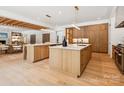 Modern kitchen with an oversized island, hardwood cabinets, and stainless steel appliances at 5311 Carmel Park Dr, Charlotte, NC 28211