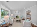 Inviting living room with a fireplace, large windows, and stylish, neutral-toned furniture at 5441 Wintercrest Ln, Charlotte, NC 28209