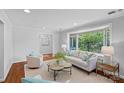 Spacious living room featuring a bay window, hardwood floors, and comfortable, neutral furniture at 5441 Wintercrest Ln, Charlotte, NC 28209